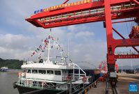 A cargo vessel prepares to depart for Yangpu Port in south China's Hainan Province along the Pinglu Canal at an operation area in Nanning Port, south China's Guangxi Zhuang Autonomous Region, Sept. 16, 2026. China opened a major new canal on Wednesday, giving its landlocked southwest a shortcut to the coast and overseas markets, particularly those in the Association of Southeast Asian Nations (ASEAN), the country's largest trading partner. Built at a cost of 72.7 billion yuan (about 10.75 billion U.S. dollars), the 134.2-kilometer Pinglu Canal runs from Nanning, capital of south China's Guangxi Zhuang Autonomous Region, to the Beibu Gulf, the closest maritime outlet for much of southwest China. (Xinhua/Cao Yiming)